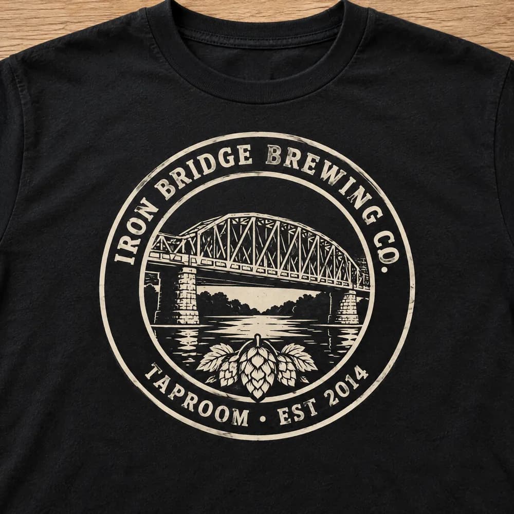 Iron Bridge Brewing circular badge on a black tee