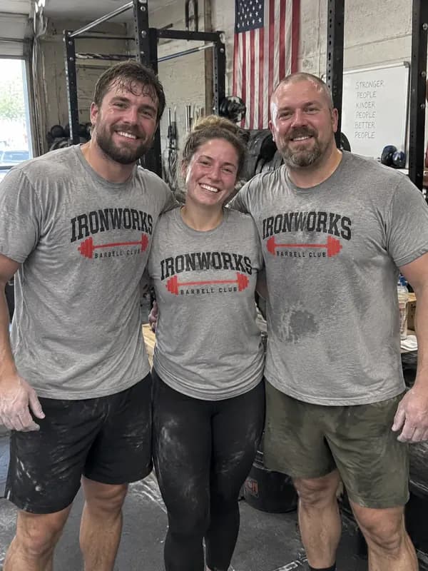 Three gym members in gray Ironworks Barbell Club shirts